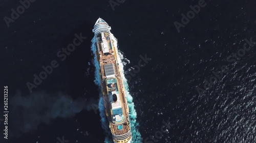 Aerial top view of luxury large cruise ship sailing full speed on open water, luxury vacation concept. Stock. Large Cruise ship sailing across The Mediterranean sea.