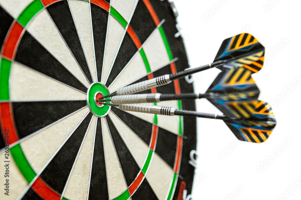 Dart in bulls eye of dartboard with shallow depth of field concept for hitting target Dart in bulls eye of dartboard with shallow depth of field concept for hitting target