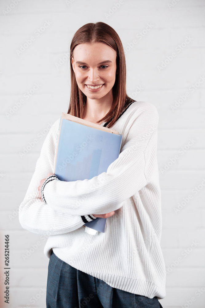 Gloomy young woman hair dressed casually making faces at camera, student girl. Positive girl having fun indoors Gloomy young woman hair dressed casually making faces at camera, student girl. Positive girl having fun indoors