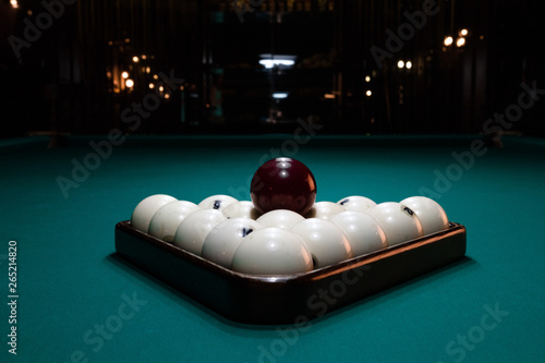 Close-up billiard balls ivory folded triangle on a table covered with green baize