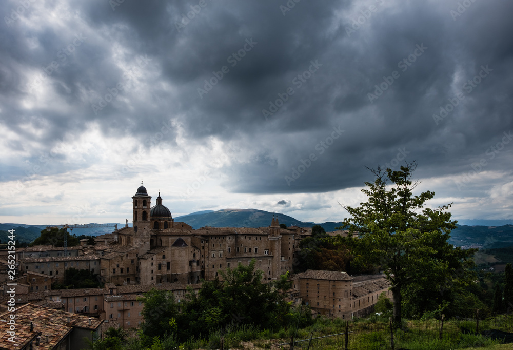 Panoramic view of the ducal palace of Urbino in central Italy with a dramatic sky