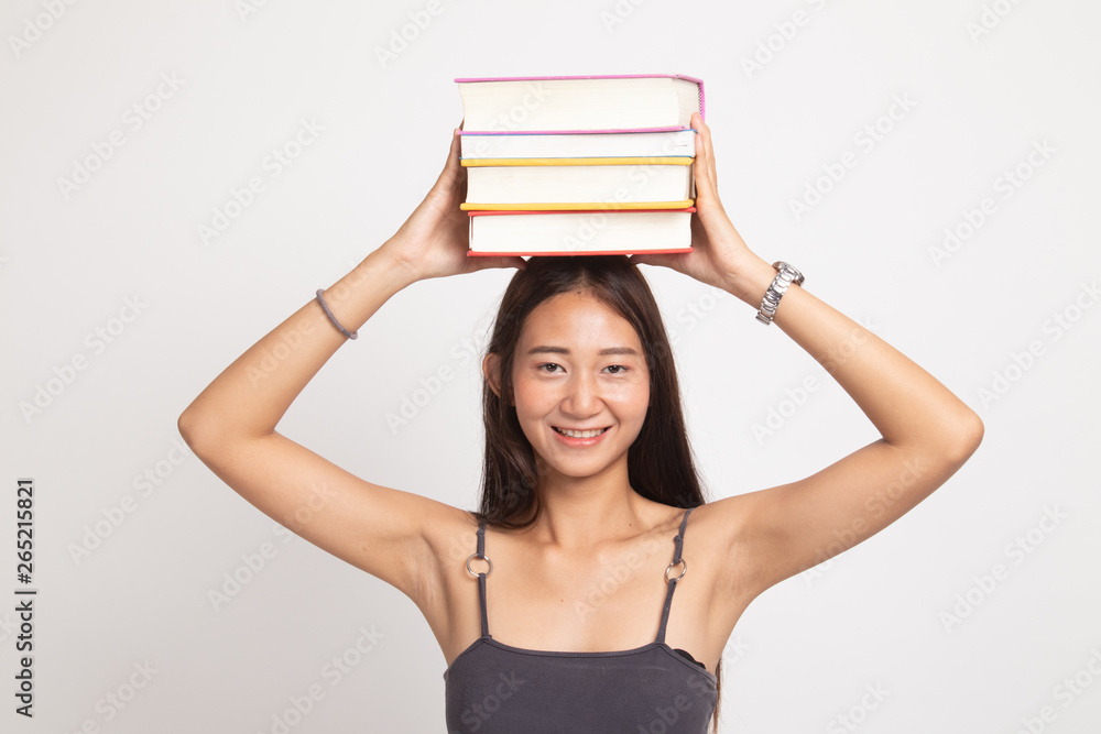 Young Asian woman studying with may books. Young Asian woman studying with may books.