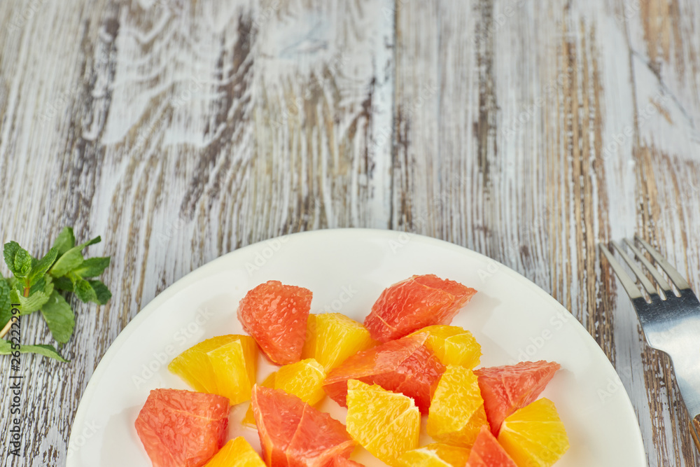 Orange-grapefruit citrus salad on a shabby wooden table. copy space. summer vitamin salad. Orange-grapefruit citrus salad on a shabby wooden table. copy space. summer vitamin salad.