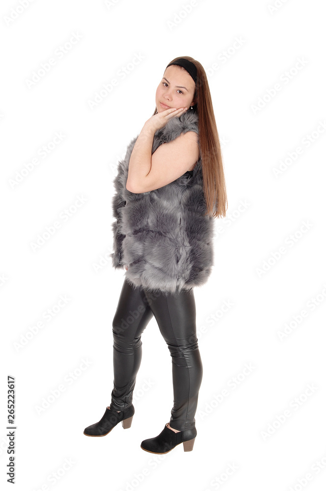 A pretty teenager girl standing in leather pants A pretty teenager girl standing in leather pants