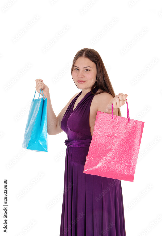 Young teenager girl holding up her shopping bags Young teenager girl holding up her shopping bags