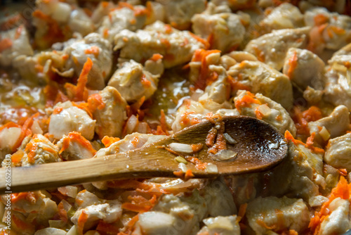 Cooking  sliced carrots and meat fried in a pan