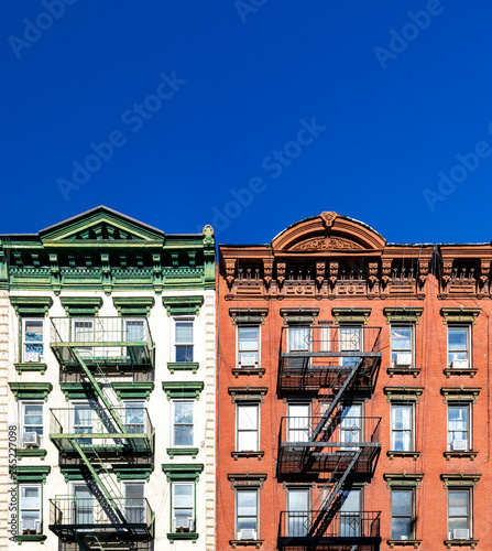 Photography Old green and red apartment buildings with empty clear blue sky background in th