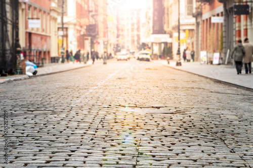 Valokuvatapetti New York City - Cobblestone street view in Soho with bright sunlight background