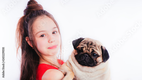 Little girl in a red dress and the Pug-dog isolated on a white background