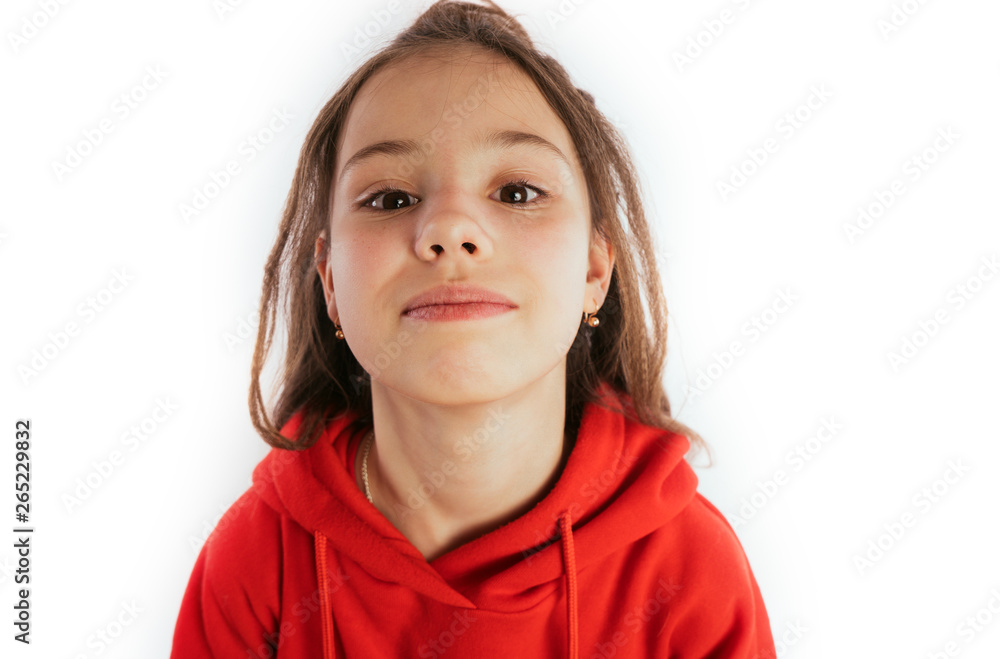 Children model on a white background. Little girl with long hair, wearing a red hoodie Children model on a white background. Little girl with long hair, wearing a red hoodie