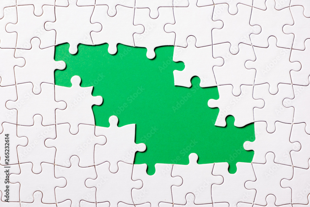 Jigsaw puzzle game piece on green background for business theme design