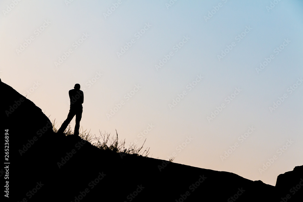 Silhouette men on the hill at sunset time. Silhouette men on the hill at sunset time.