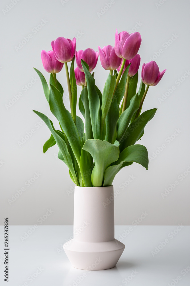 Pink spring tulip flowers in ceramic vase Pink spring tulip flowers in ceramic vase