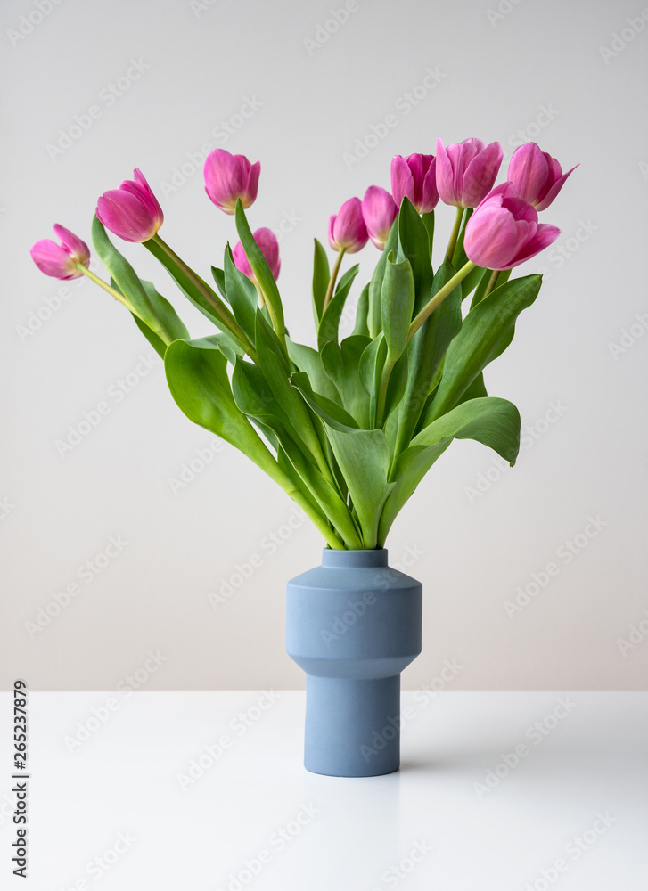 Pink spring tulip flowers in ceramic vase
