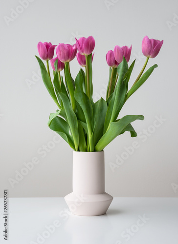 Pink spring tulip flowers in ceramic vase