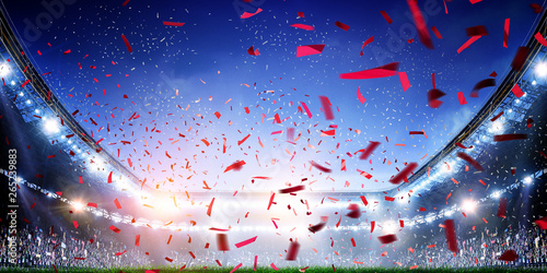 Football stadium background with flying confetti photo
