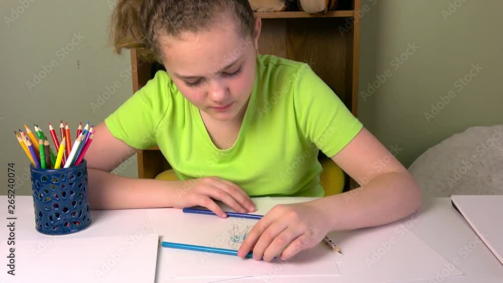 View of student drawing a picture in progress. View of student drawing a picture in progress.