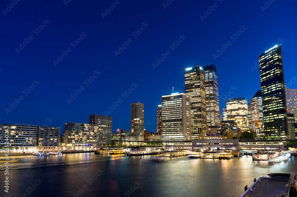 Sydney skyline at night. Business office buildings and Circular Quay cityscape