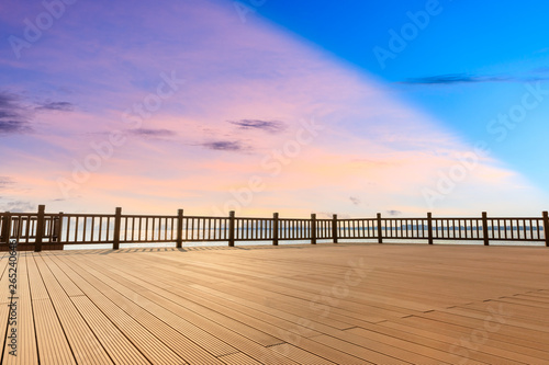Lakeside wood floor platform and sky clouds at sunset