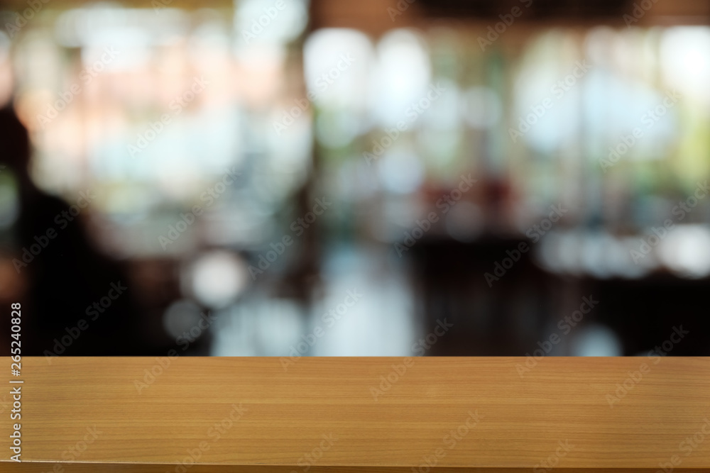 Empty dark wooden table in front of abstract blurred bokeh background of restaurant . can be used for display or montage your products.Mock up for space. Empty dark wooden table in front of abstract blurred bokeh background of restaurant . can be used for display or montage your products.Mock up for space.
