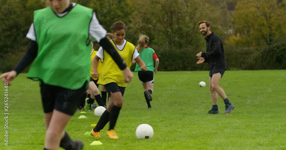 4K Soccer coach training with girls' team shouting encouragement & giving high 5s 4K Soccer coach training with girls' team shouting encouragement & giving high 5s