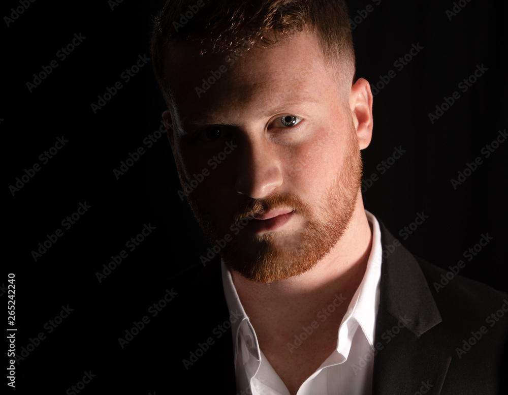 Fototapeta premium handsome man is watching from the shadows