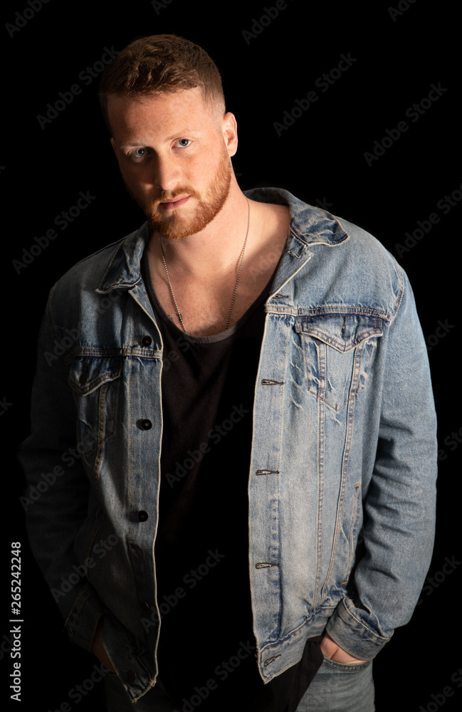 Naklejka premium handsome man with beard and hands in pockets is watching you