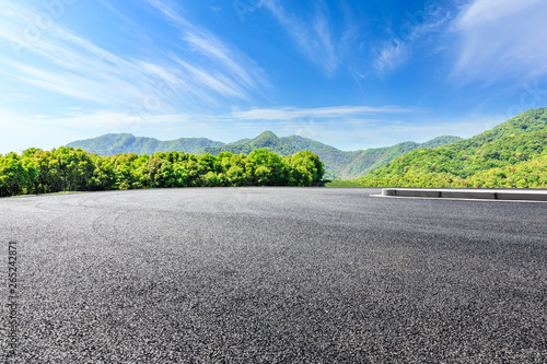 Country road and green mountains natural landscape under the blue sky © ABCDstock