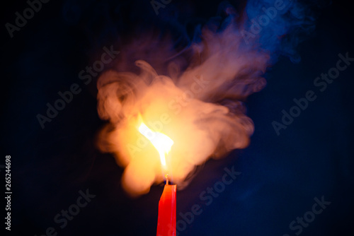 Candle flame in the wind. Colored smoke with shining blue and orange gradient. Warm glow texture with fire.