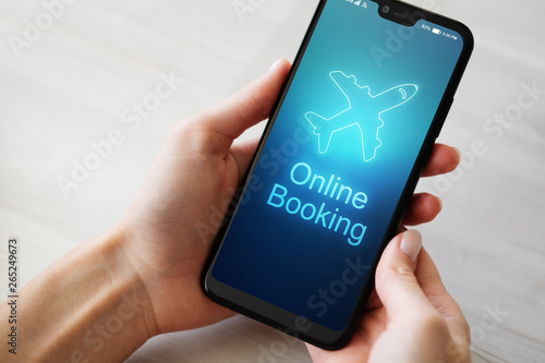 Flight booking application on mobile phone screen. Business and technology concept.