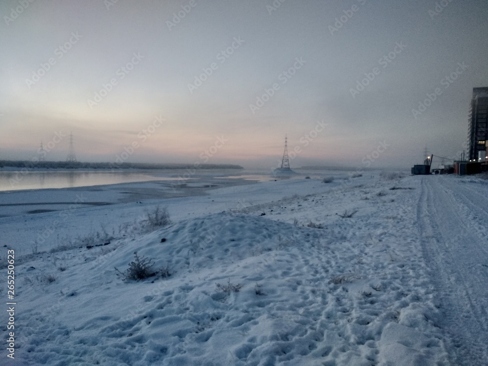 Fototapeta premium winter landscape with frozen river and blue sky