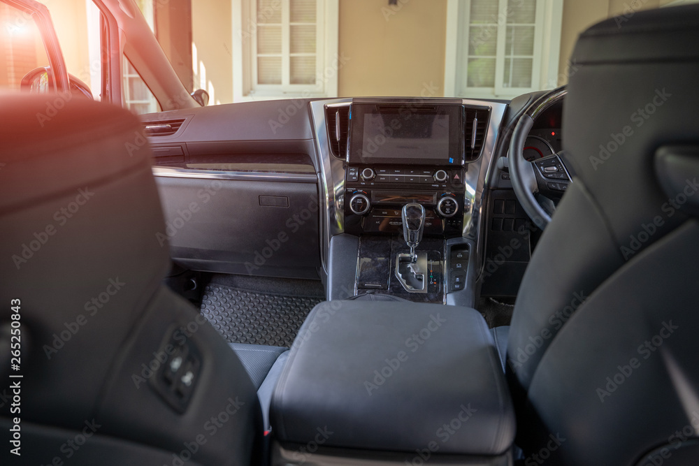 Dark luxury car Interior - steering wheel, shift lever and dashboard. Car interior luxury.