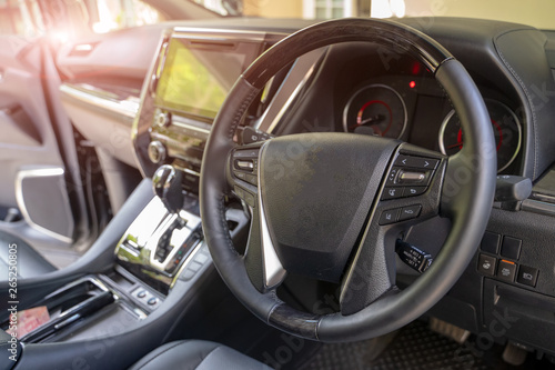 Dark luxury car Interior - steering wheel, shift lever and dashboard. Car interior luxury. © visoot