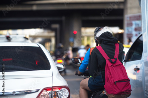 car and motorcycle on road in city