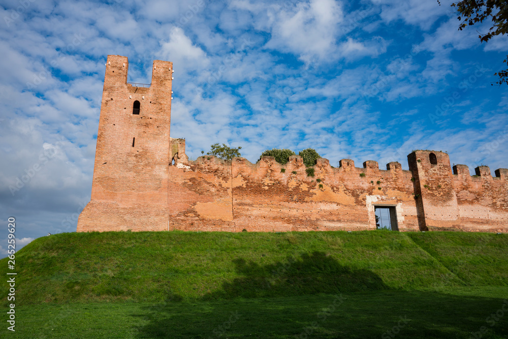 city wall with merlons and tower on green hill in Castelfranco Veneto, Italy
