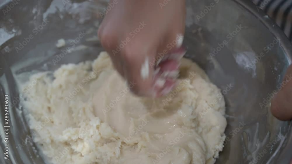 Close up view of married baker’s hands kneading the dough on the table Close up view of married baker’s hands kneading the dough on the table