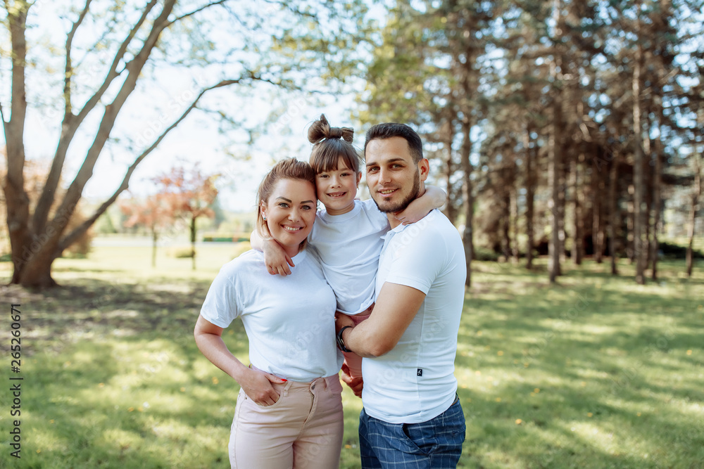 Happy family outdoors. Girl, mother, dad Happy family outdoors. Girl, mother, dad