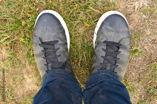 Feet close up. Traveler's dirty shoes. Man's shoes after the hike. Shoes are black in dust.