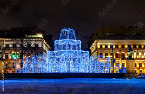 Winter holidays. Street Christmas decorations in the evening. Admiralty building, Winter fountain of hundreds of small lights in the Alexander Garden St. Petersburg, Russia