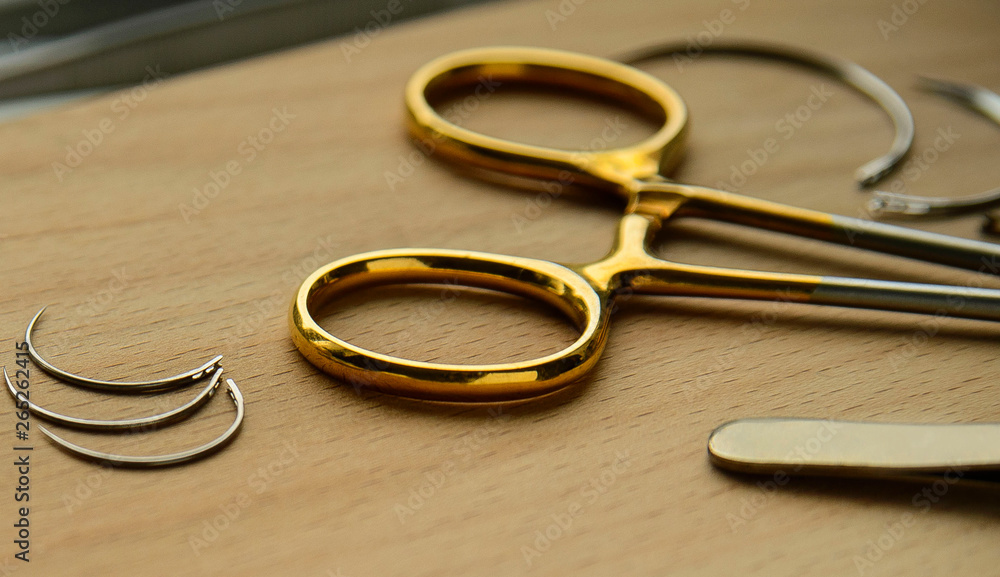 surgeon's tools on wooden background surgeon's tools on wooden background