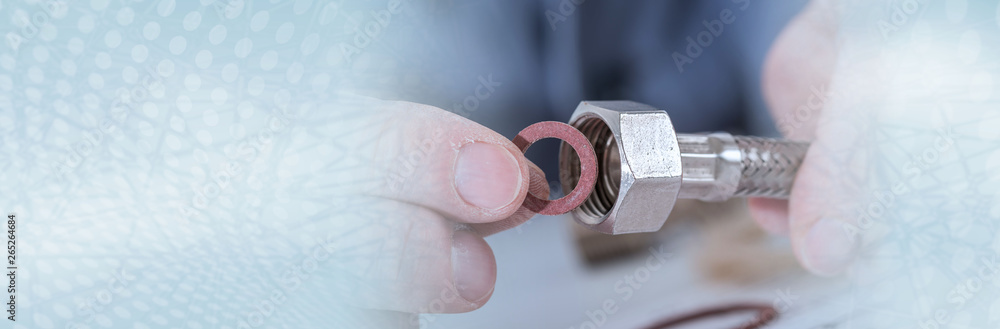 Plumber putting a gasket on a plumbing fitting. panoramic banner - obrazy, fototapety, plakaty 
