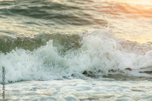 Soft wave on the beach with sunlight.