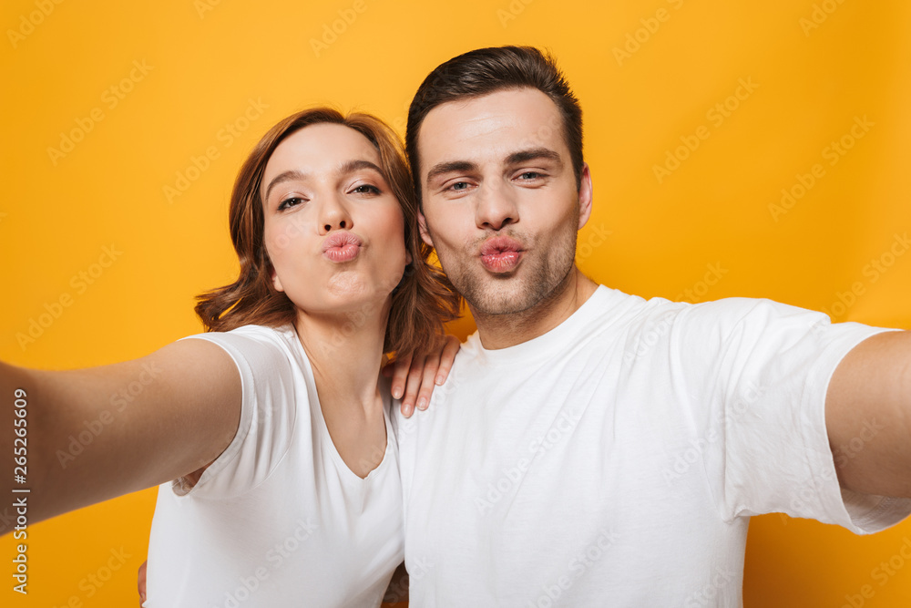 Excited beautiful couple wearing white t-shirts standing Excited beautiful couple wearing white t-shirts standing