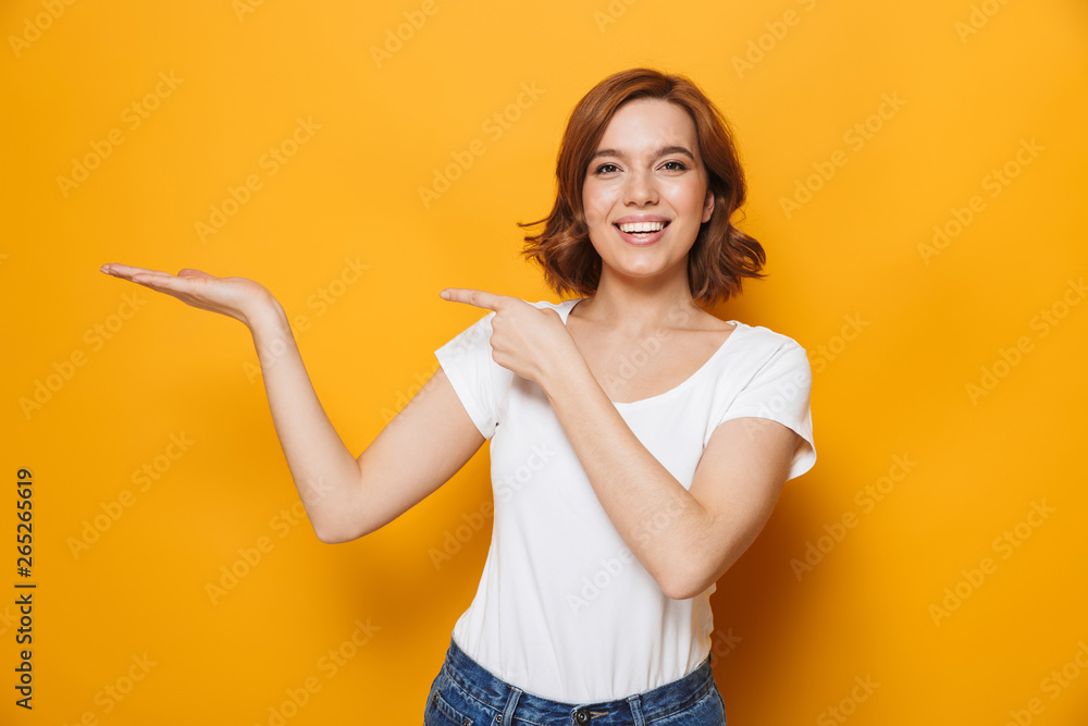 Cheerful young girl wearing t-shirt standing Cheerful young girl wearing t-shirt standing