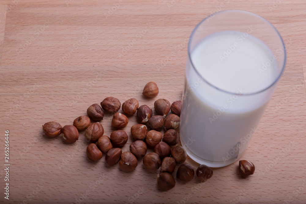 Glass of Hazelnut milk and organic Hazelnut on wooden background, Alternative Milk. Nuts milk Glass of Hazelnut milk and organic Hazelnut on wooden background, Alternative Milk. Nuts milk