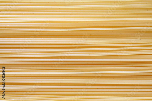 Spaghetti pasta vermicelli raw background lined in a row