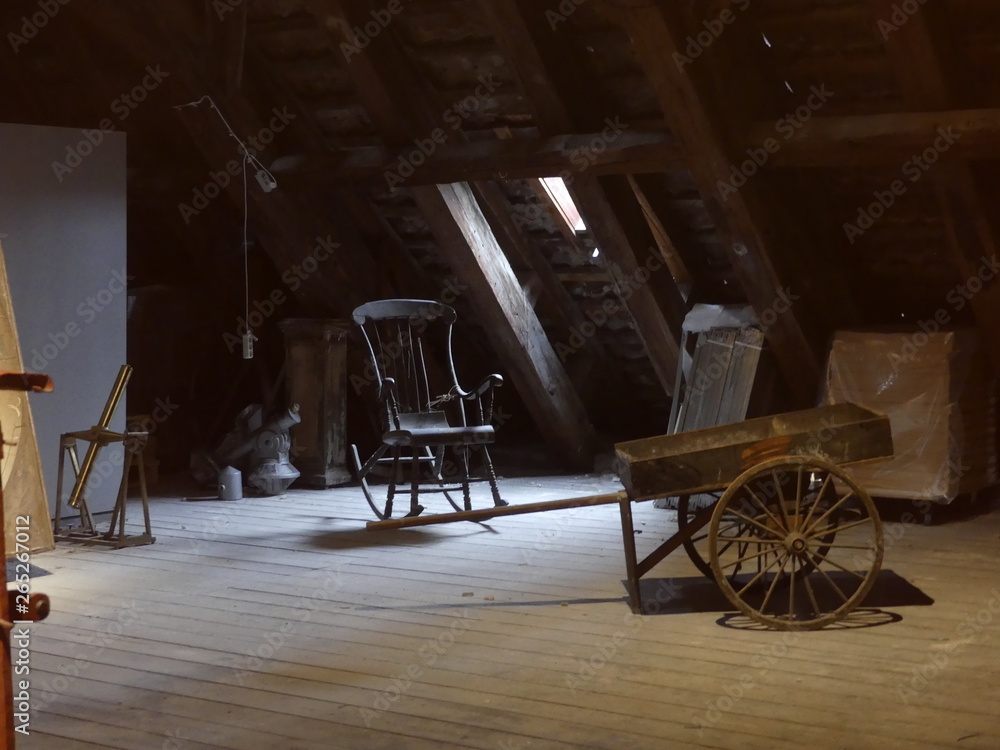 Old rocking chair in the attic. Old chair in the attic. Cart in the attic. Strict, unnecessary things in the closet.