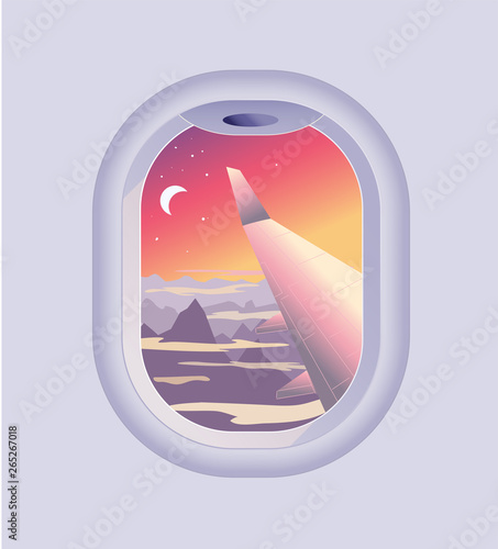 View from airplane window. Mountain landscape at sunrise or sunset. Flights and Travel