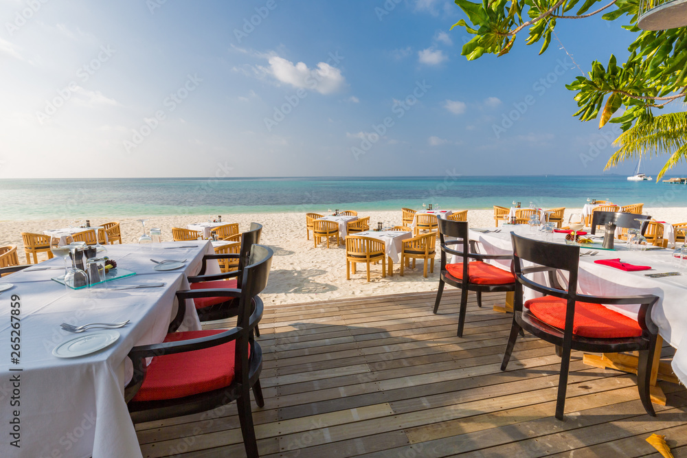 Beach restaurant with sea view, luxury tropical resort outdoor restaurant scene