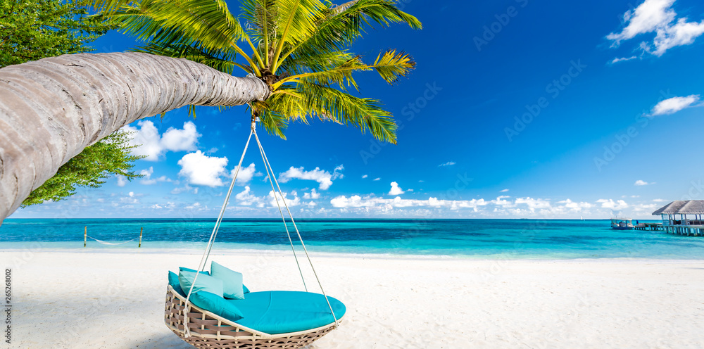 Tropical beach background as summer landscape with beach swing or hammock and white sand and calm sea for beach banner. Perfect beach scene vacation and summer holiday concept. Boost up color process